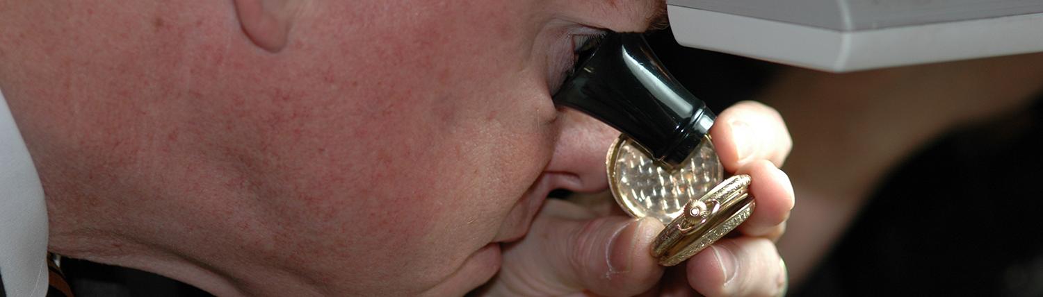 Man views an artifact under magnification