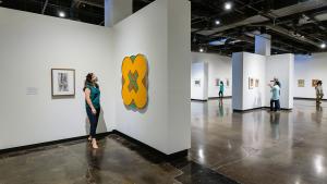 Individuals viewing art work in a gallery