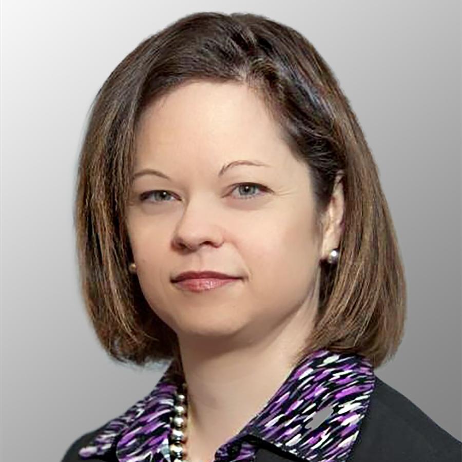 Head shot of a female with brown chin length hair wearing a purple shirt and black suit coat
