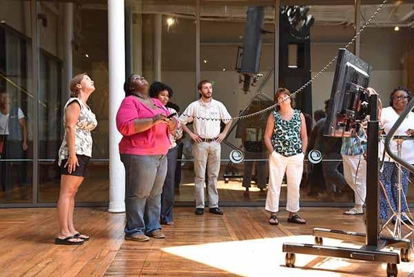Workshop participants get hands-on practice moving the telescope.