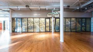 Glass wall featuring sepia toned illustrated map of Columbia applied to it with sign above that reads Gervais Street Room