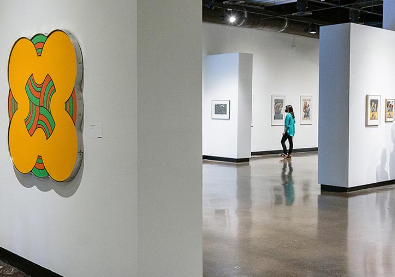 Gallery with a graphic shown on the wall and other art around the room