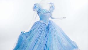 Mannequin on white background wearing light blue off the shoulder ballgown with twirling skite in light blue layers of chiffon.