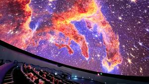 Guests in the planetarium dome look up at projection of the Pillars of Earth on the planetarium dome
