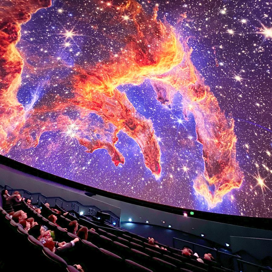 Guests in the planetarium dome look up at projection of the Pillars of Earth on the planetarium dome