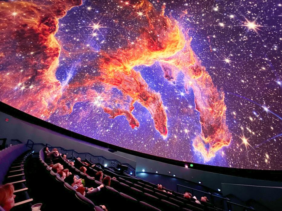 Guests in the planetarium dome look up at projection of the Pillars of Earth on the planetarium dome