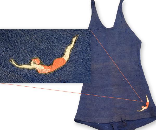 Circa 1920 Jantzen men's wool bathing suit. Blue with a signature logo on their suits, depicting a diving woman in a bright red suit.