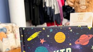 Book on Display Featuring Cover with A starry sky and Planets Titled Kid Astronomer The Space Explorer's Guide to the Universe