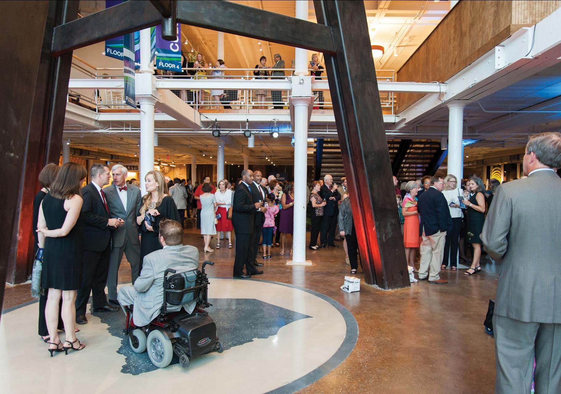 Events guests mill about around the iconic telescope legs at the South Carolina State Museum.