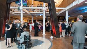 Events guests mill about around the iconic telescope legs at the South Carolina State Museum.