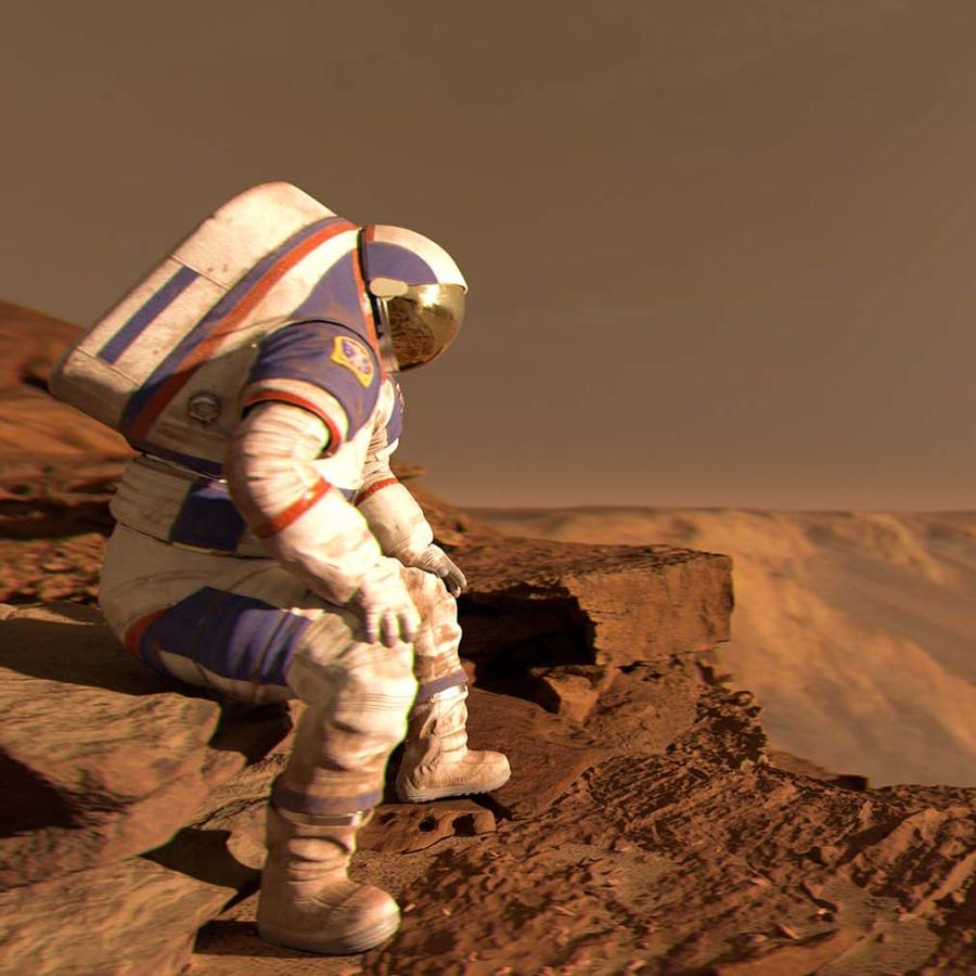 Astronaut sits wearing a white spacesuit with a red, dusty landscape visible behind them