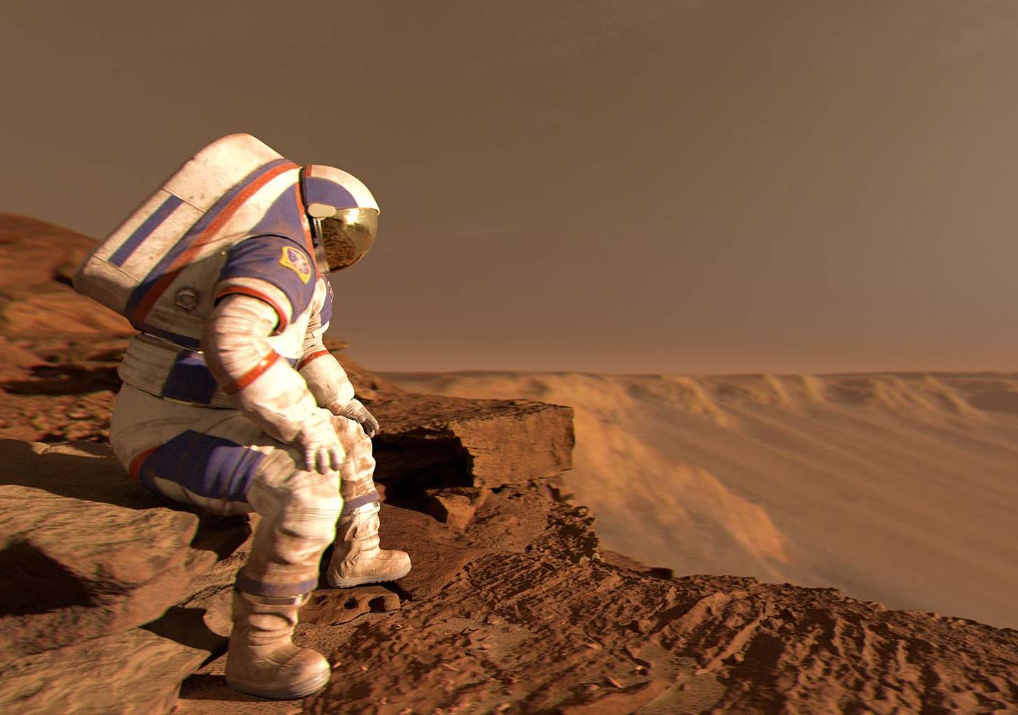 Astronaut sits wearing a white spacesuit with a red, dusty landscape visible behind them