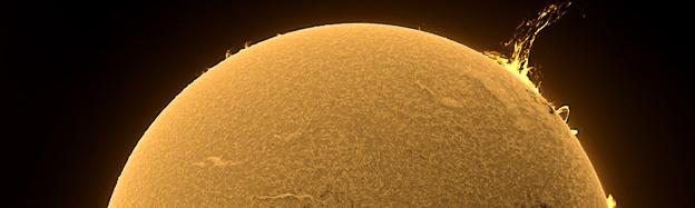 Image of the Sun taken from the Observatory with solar flare visible on upper right side