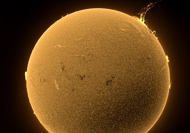 Image of the Sun taken from the Observatory with solar flare visible on upper right side