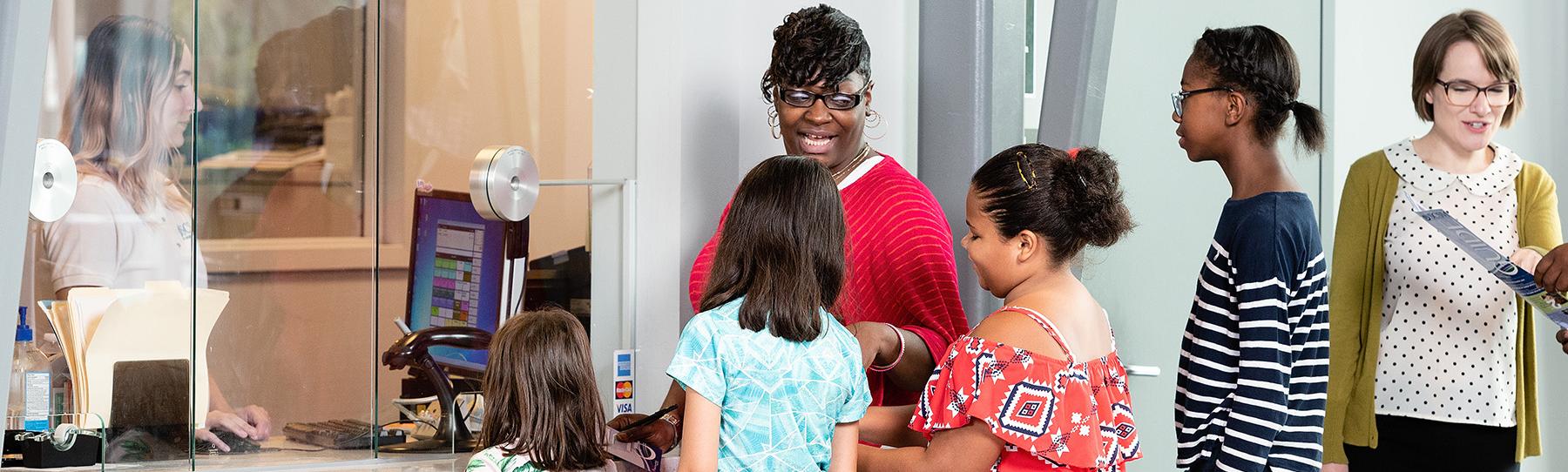 Students and chaperone wait in line at the Group Visits window