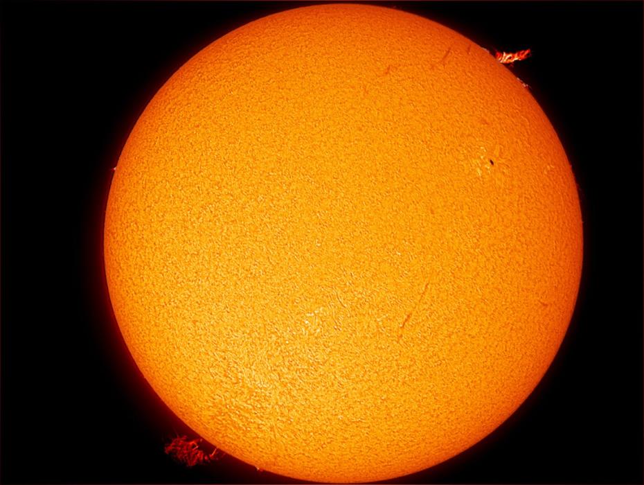 Black and white image of the Sun from the SCSM observatory, with a large sunspot group to the far left.