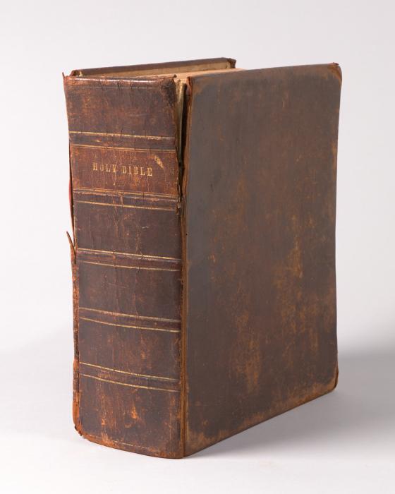 Large open, antique Bible with Title Page Showing includes black lettering and the words "Holy Bible"