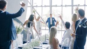 Wedding Party Welcomes Bride and Groom as they enter reception in the planetarium lobby