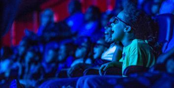 Young girl gasps in delight as she experiences a show in the in the 4D theater audience at the State Museum.