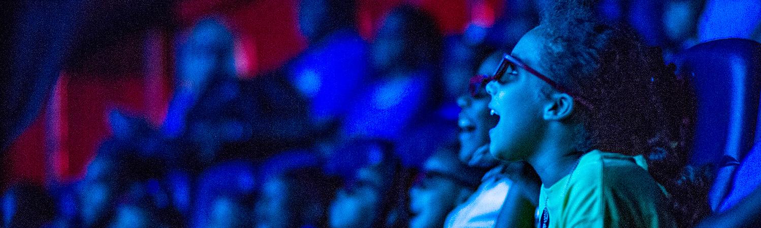 Young girl gasps in delight as she experiences a show in the in the 4D theater audience at the State Museum.